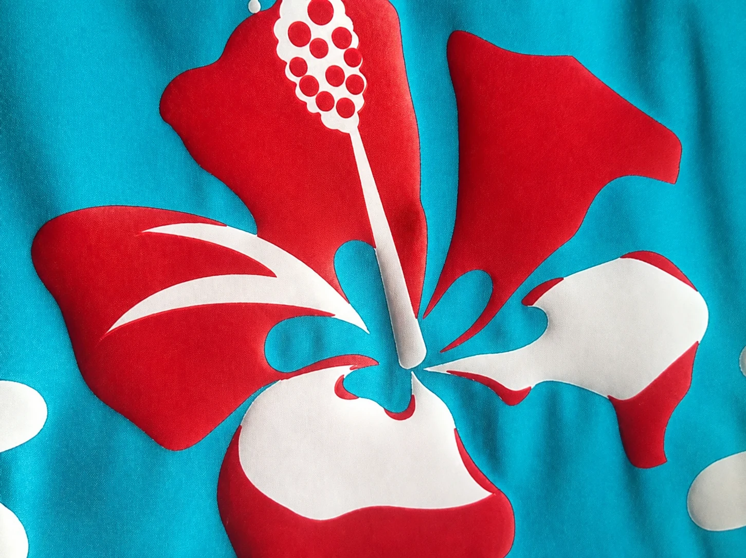 Red and white floral print on turquoise fabric from the Yunrui presentation