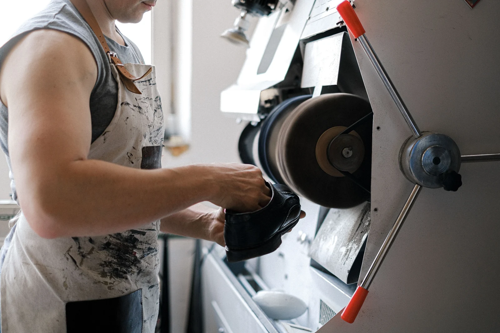 Footwear being finished on a workshop machine